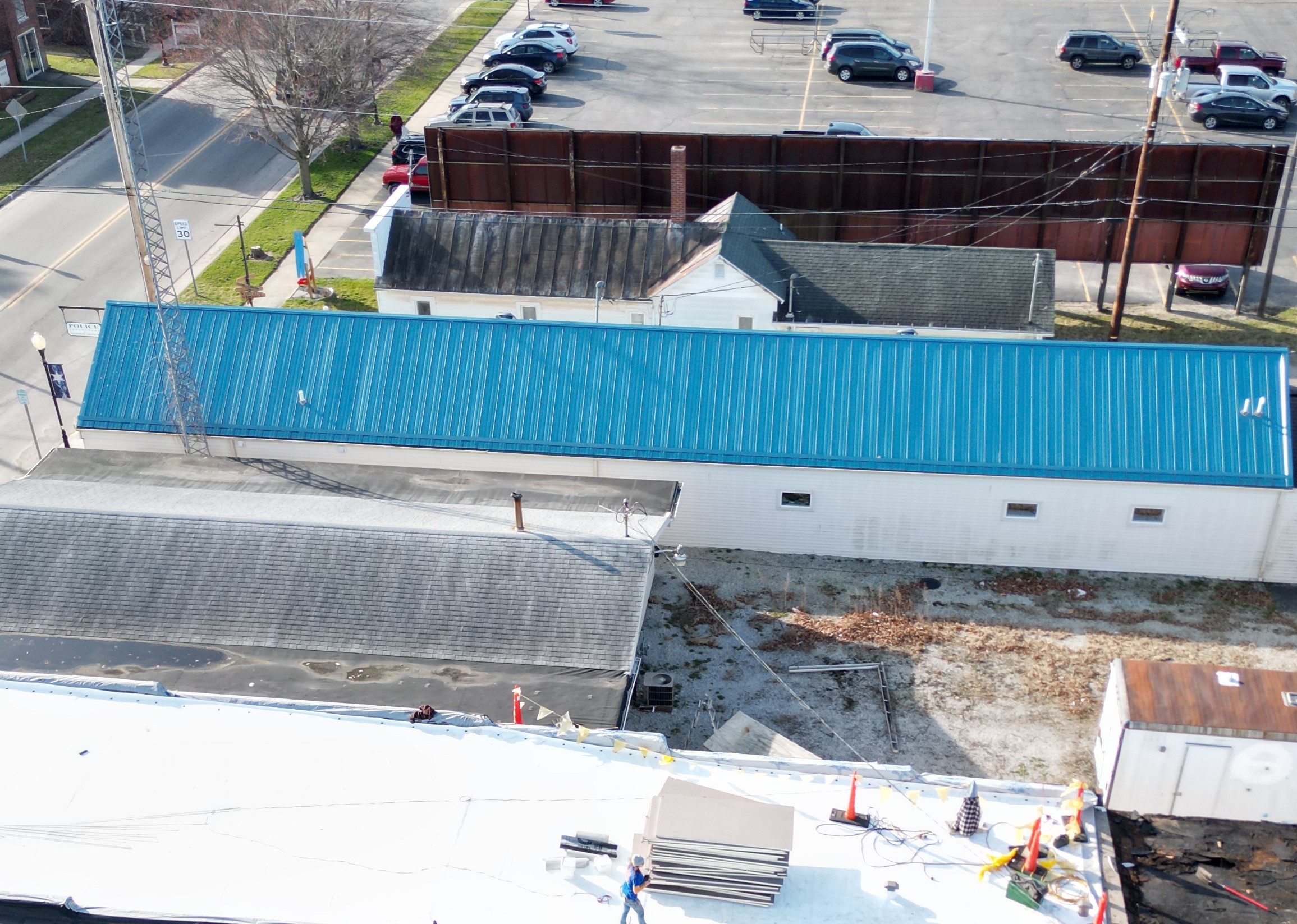 guy walking on commercial roof replacement